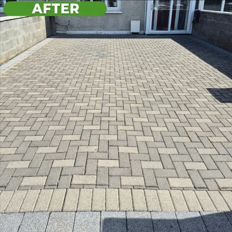 The same cobblelock driveway after cleaning, back to an even sand colour.
