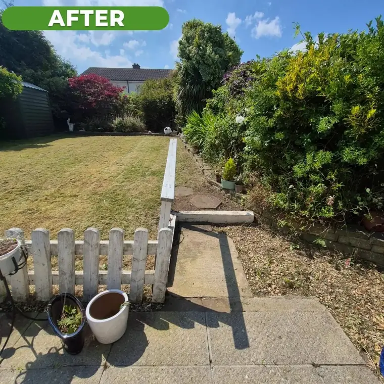 The same front garden after clearance, path and beds clear.