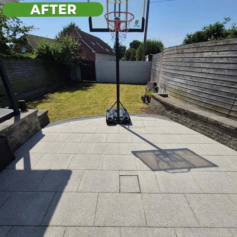 The same rear slab yard after cleaning, slabs a clean pale grey.