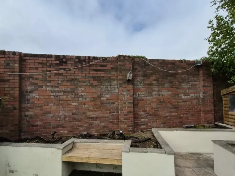 Walled yard cleaned down, brickwork and render washed.